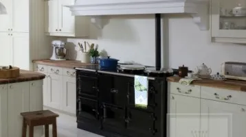 Image of kitchen using traditional wood counter tops and cream cabinets