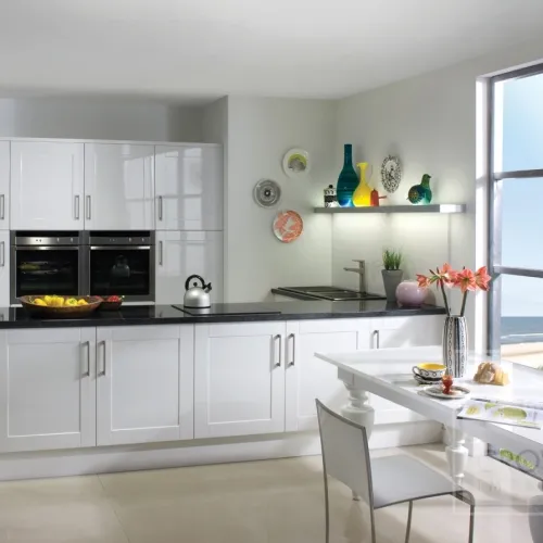 Image of kitchen with white shaker gloss kitchen cabinets and black accents