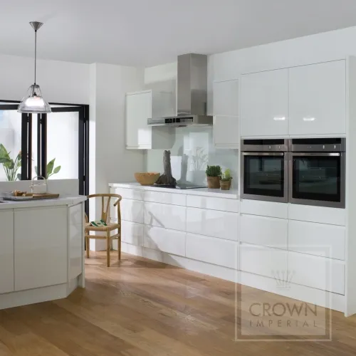 Image of kitchen with white cabinets and counters and wood floor